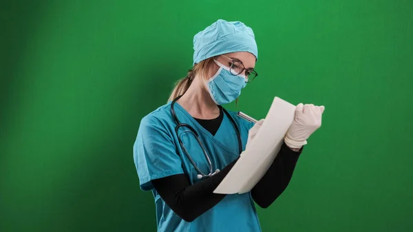 Female doctor takes notes in a file