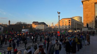 BRUSSELS, BELGIUM - NOVEMBER 26, 2025 - Group of people gathering in Brussels city for a protest at sunset