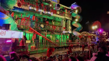 PARIS, FRANCE - DECEMBER 16, 2025 - Paris Christmas Market funhouse facade glowing with colorful lights and holiday decorations