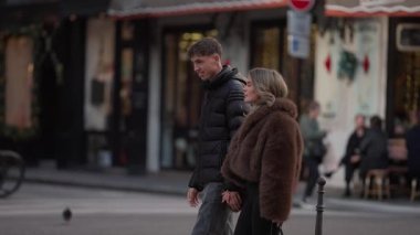 Bir çift, Paris 'te bir sokakta el ele yürür. Fransa' da, erkek ve kadın, güneşli bir günde, dükkanların ve kafelerin etrafında romantik bir buluşmanın tadını çıkarırlar..