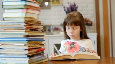 Küçük kız kitap okuyor.