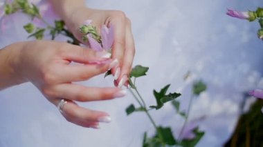 Yeni evli bir alanda - gelin ve damat yürüyüş çiçeklerle oynuyorlar