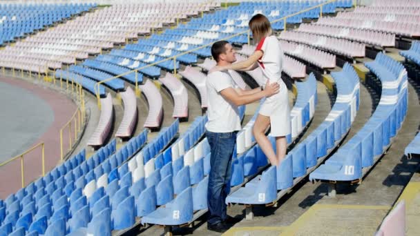 Lovers kiss i en fotbollsarena — Stockvideo