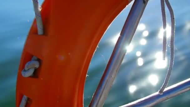 Life preserver on a yacht - the reflection of the sun in water — Stock Video