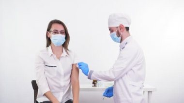 Coronavirus vaccination. nurse or doctor, in protective mask and medical gloves, injects vaccine into patients shoulder. new vaccine for prevention, immunization and treatment of coronavirus