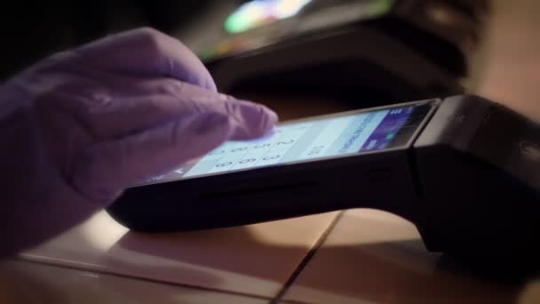 NFC technology. close-up. waiter, in protective gloves, prints amount into terminal for contactless payment. Paying by phone on electronic payment machine or card reader. Mobile, wireless payment — Stock Video