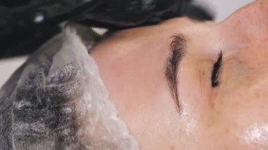 beauty therapy. facial massage. Cosmetology skin care. close-up. woman is getting facial skincare massage, tonied facial skin and muscles, doing lymphatic drainage, at beauty clinic. anti-aging