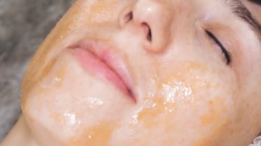 beauty therapy. Cosmetology skin care. facial massage. close-up. beautician applies massage honey to womans face, rubs it with massage movements over face. anti-aging procedure. cosmetic procedures