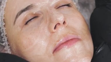 beauty therapy. facial massage. Cosmetology skin care. close-up. woman is getting facial honey massage, tonied muscles and facial skin lymphatic drainage, at beauty clinic. anti-aging procedure