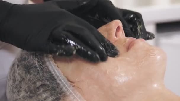 Beauty therapy. facial massage. Cosmetology skin care. close-up. woman is getting facial honey massage, tonied muscles and facial skin lymphatic drainage, at beauty clinic. anti-aging procedure — Stockvideo