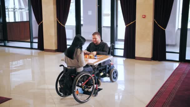 Wheelchair. disability. disabled young man and woman are drawing with paints, sitting in wheelchairs at table. creative group lessons for people with disabilities. Education, relationship and humanity — Stock Video