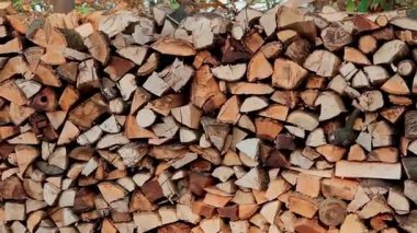 Isıtmak için düzgünce yerleştirilmiş yakacak odunları yakın plan. Çeşitli ağaç türlerinden kütük yığını.