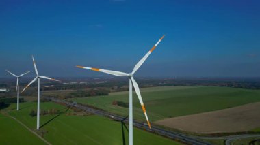 Alman otobanının yanındaki yeşil alanda duran rüzgar türbini yenilenebilir temiz yeşil eko enerji üretiyor. Hız rampası hiper hareket zamanı hızlandırılmış drone 'u çek 