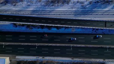 Berlinde yoğun bir otoyol, binalar ve açık bir kış gününde karla kaplı yerleşim alanları var. İHA kamerası aşağıya bakıyor