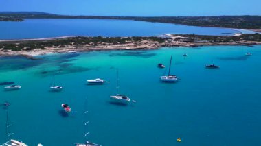 Turkuaz Akdeniz suları, tekneler ve güneşli gökyüzünün altında Estany Pudent tuz düzlükleri olan kıyı şeridi. Uçuş üstlerinden ters uç, panorama göz gezdirme aracı.