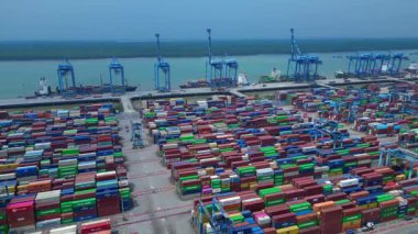 Hava görüntüsü, iskele tarafında renkli nakliye konteynırları ve büyük vinçlerle batı limanını gösteriyor. panorama yörünge dronu