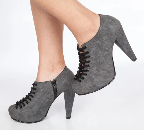 Topuklu ayakkabı bağcıklarımı beyaz arka plan üzerinde siyah ile gri kadın ayakları — Stok fotoğraf