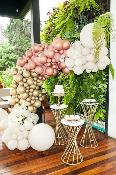 Place decorated with balloon arch, sweets and cake for reception - candy table.