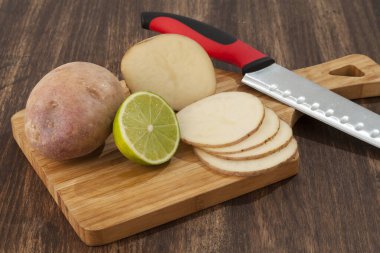 Preparation Sliced Potatoes With Lemon; Photo On Wooden Background