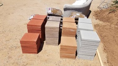 Stacks of Four Different Colored Pavers on Ground, Building a Backyard Patio. High quality photo