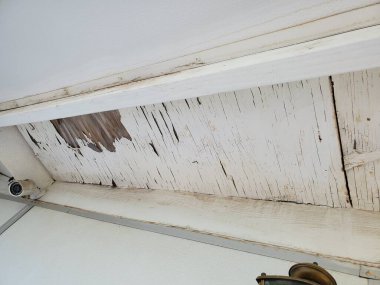 Palamut soyulmuş beyaz boya ve evin çatısının yakınındaki saçaklarda Wter hasarı. Yüksek kalite fotoğraf