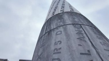 Valenciennes, Fransa - 01 26 2026: Valenciennes 'deki Litanie Anıtı' nın alçak açılı çekimi, gökyüzüne doğru yükselen, inancı, hafızayı ve yerel mirası sembolize eden uzun oymalı bir sütun..