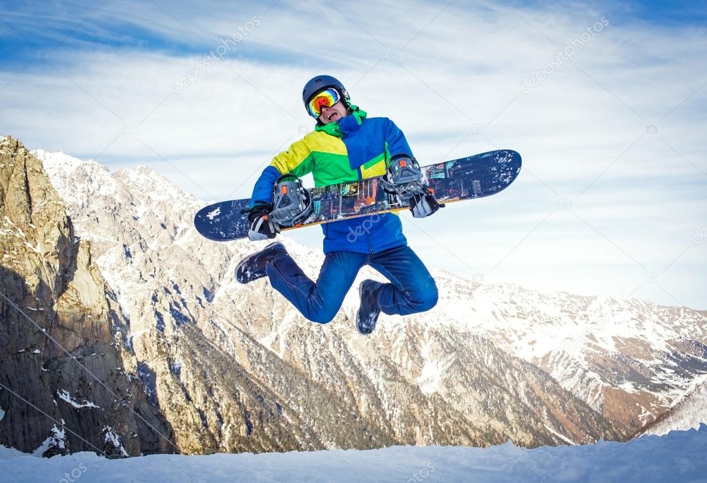Snowboarder hold snowboard on top of hill close up portrait, snow mountains snowboarding on slopes