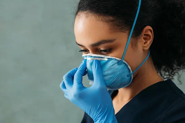 Close up of young medical specialist wearing a respirator