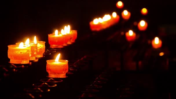 Bokeh de velas rojas en una iglesia europea — Vídeo de stock