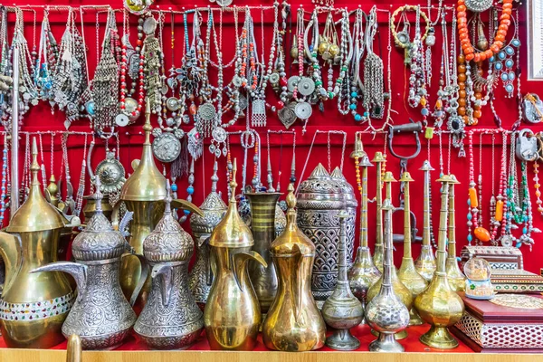Middle East, Arabian Peninsula, Oman, Ad Dakhiliyah, Nizwa. Traditional tea pots and jewelry for sale in the souk in Nizwa, Oman.