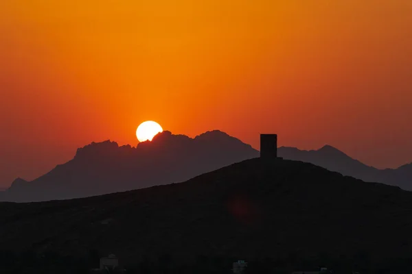 Middle East, Arabian Peninsula, Oman, Ad Dakhiliyah, Nizwa. Sunset over the mountains in Nizwa, Oman.