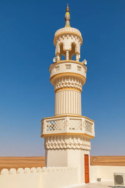 Middle East, Arabian Peninsula, Oman, Ash Sharqiyah North, Bidiya. The minaret of a mosque in the desert of Oman.