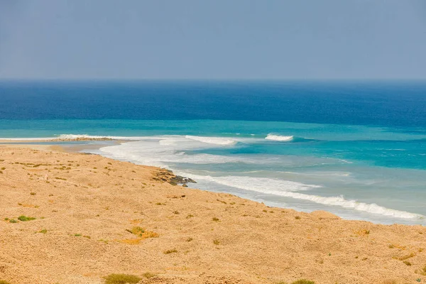 Middle East, Arabian Peninsula, Oman, Al Batinah South, Sur. Surf along the coast of the Arabian Sea.