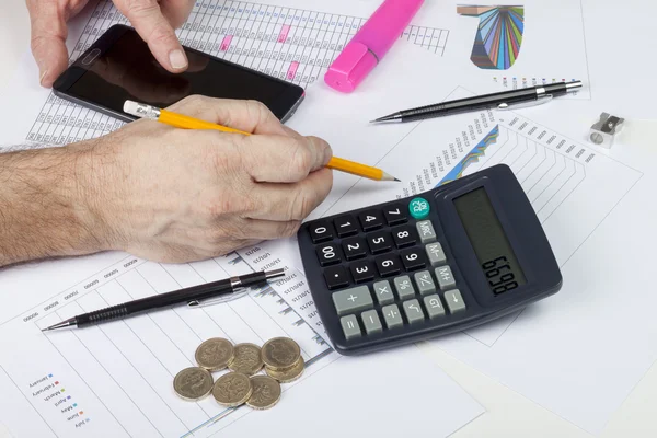 Calculating accountant interrupted by his smart phone — Stock Photo, Image