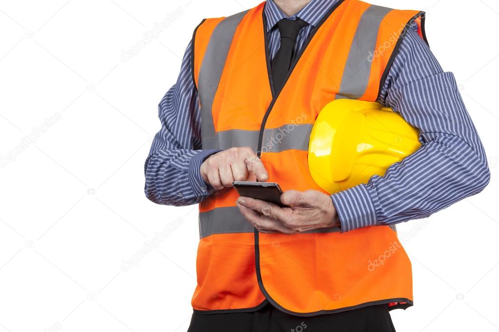 Building Surveyor in orange visibility vest using his smartphone