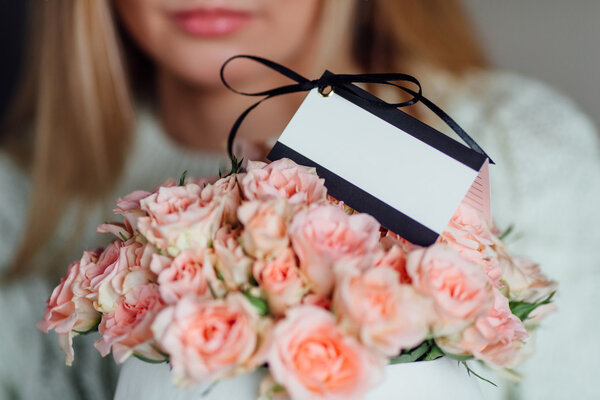 Girl holding bouquet with card delivery