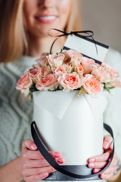 Girl holding bouquet with card delivery