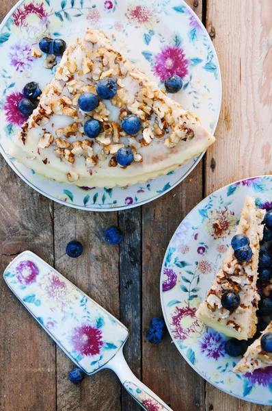 Tranche de délicieux gâteau aux myrtilles fraîches sur fond en bois — Photo