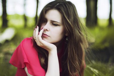 Young beautiful girl in a pink coat and pink short dress boots r