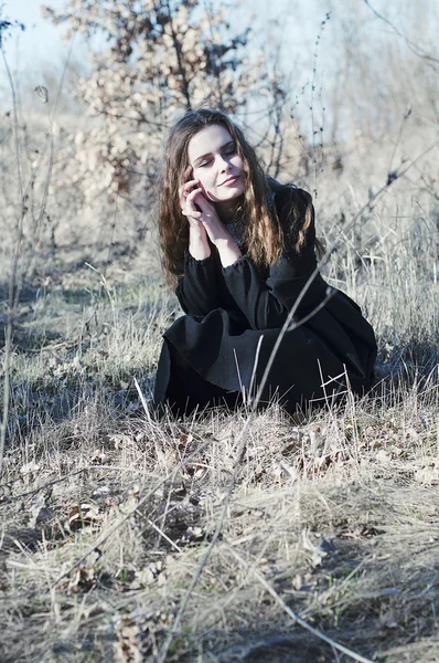 Young beautiful girl in a black dress, black coat and black hat — Φωτογραφία Αρχείου