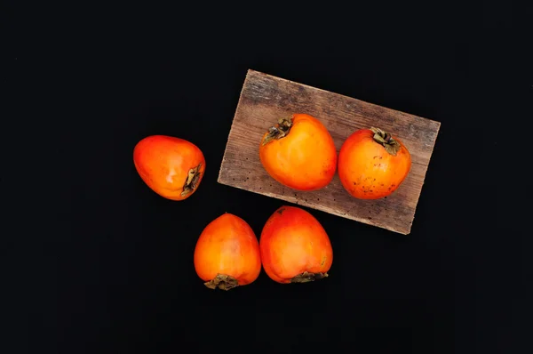 Persimmonon black background. Fresh organic persimmon. Fresh per — Stock Photo, Image