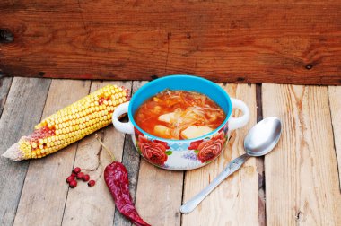 Traditional Ukrainian Russian vegetable borscht on the old woode clipart