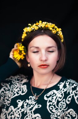 Wreath on girl head. Young beautiful woman portrait with long ha