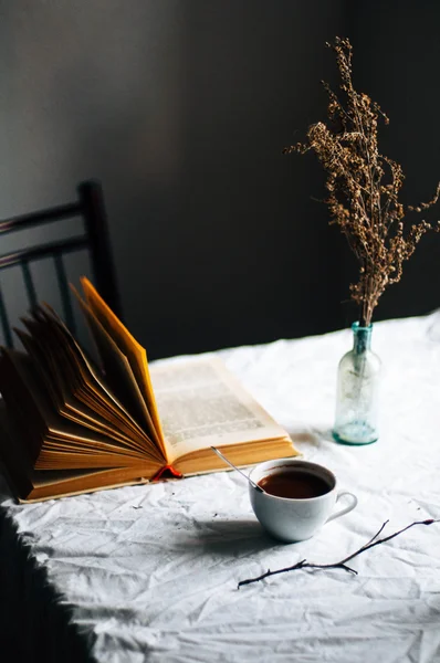 Verse warme koffie op een stapel boeken op een tafel bedekt met een wh — Stockfoto