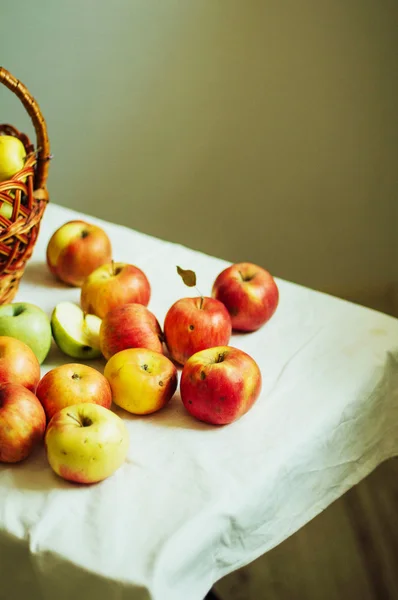 Apples  on white table. Sweet apples on table on bright backgrou