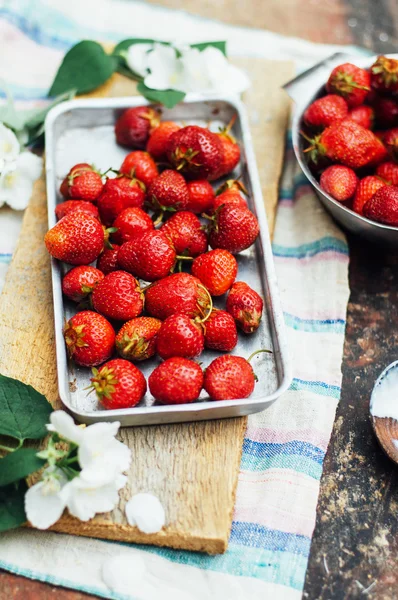 Fresh  ripe strawberries and yellow cherries laid out on the dis