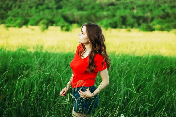 Young woman stay is burned field. Woman stands facing the camera — 스톡 사진