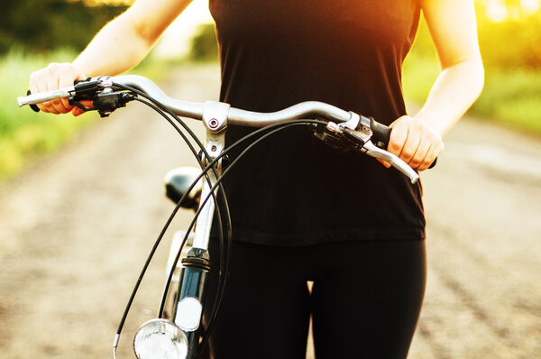 Detail of a bicycle. Woman riding her bicycle. Bicycle  on road 