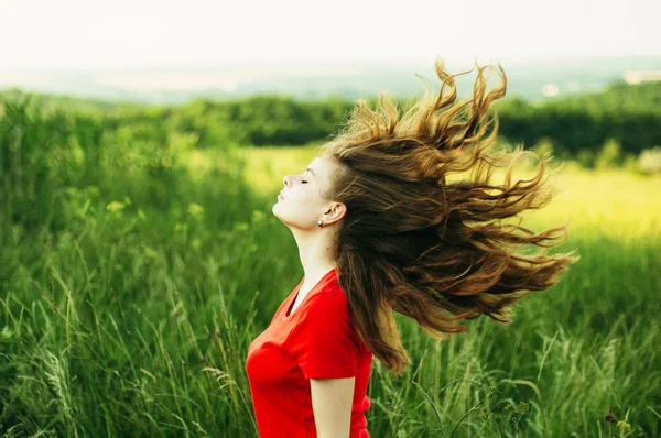 Young woman stay is burned field. Woman stands facing the camera Stock Picture