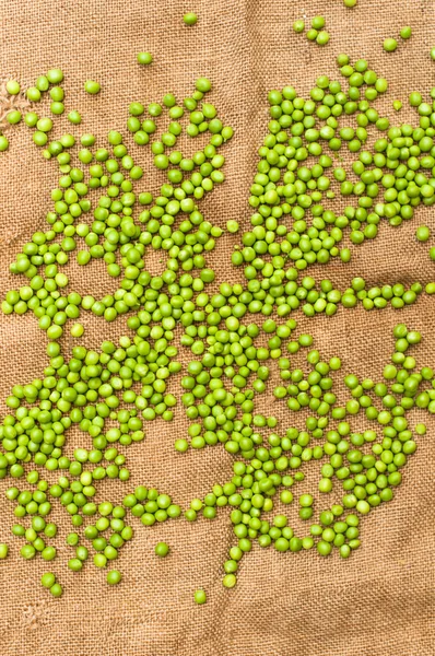 Frozen peas  on a table. Pea pods on green background — Stock Photo, Image